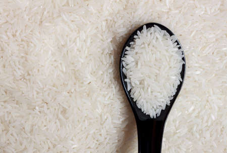 grain rice, spoon on grain rice background.の写真素材