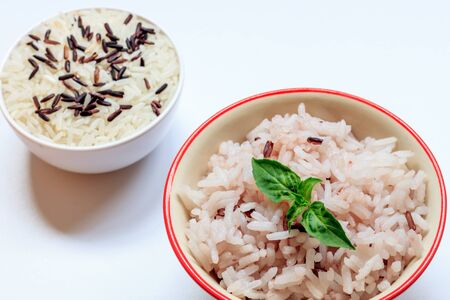 selective focus brown rice,leaf in bowl and rice seed in bowl on the white background.の写真素材