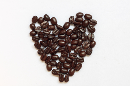 Love shape by coffee beans on white background.の写真素材