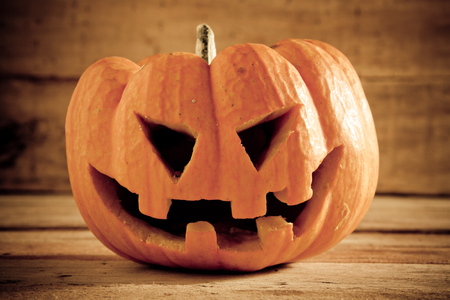 pumpkins on wood background by dark light tone.の写真素材