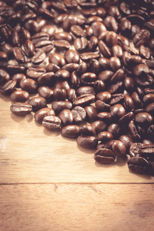 selective focus coffee bean on wood background.の写真素材