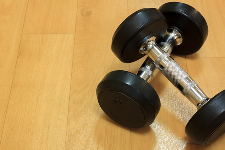 Dumbbells on the wood background.の写真素材