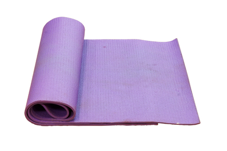 old purple yoga mat on white background with clipping path.の写真素材