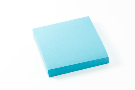 blue notepaper on white background.の写真素材