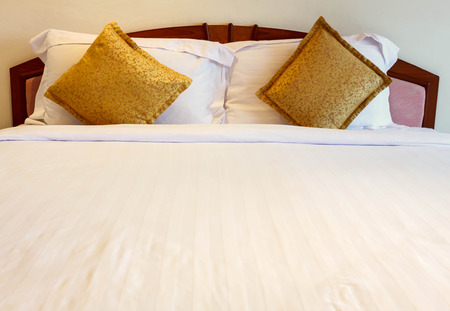 Bed, pillow, blanket in the hotel.の写真素材