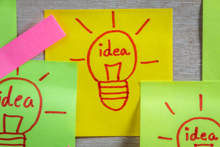 Inspiration concept  light bulb idea on colorful sticky note pads .