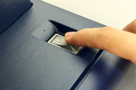 Finger's someone is closing switch copy machine .