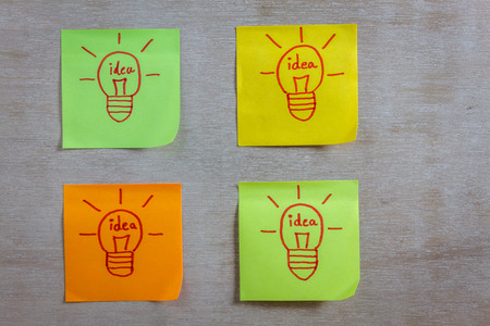 Inspiration concept  light bulb idea on colorful sticky note pads .