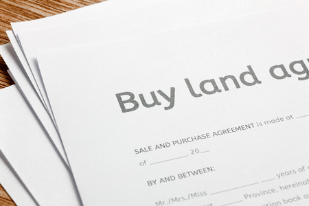 land contract form on wood background.の写真素材