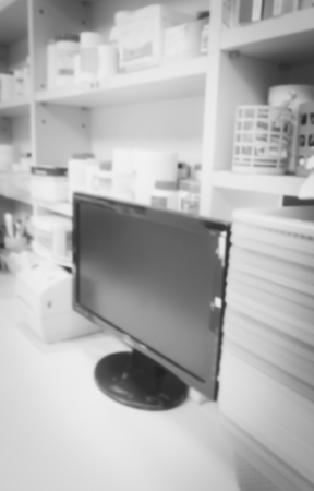 blur background the medicine drug shelves with PC computer in drug store shop or medicine store shop.の写真素材