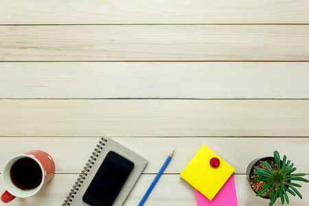 Top view notebook,pencil,black coffee,tree,mobile phone,note paper on office desk background.の写真素材