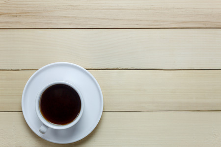 Top view black coffee on wood table.の写真素材