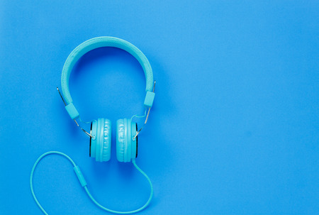 Top view blue headphones on blue background with copy space.の写真素材