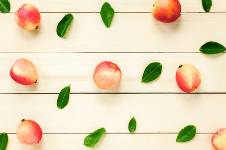Top view red apple with leaf on wooden.