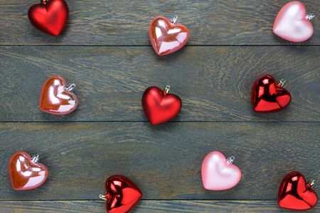 Top view red and pink heart shape pattern on wooden background.の写真素材