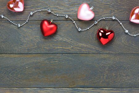 Top view red and pink heart shape also gem clothesline on wooden background with copy space.の写真素材