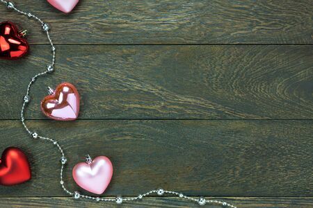 Top view red and pink heart shape also gem clothesline on wooden background with copy space.の写真素材