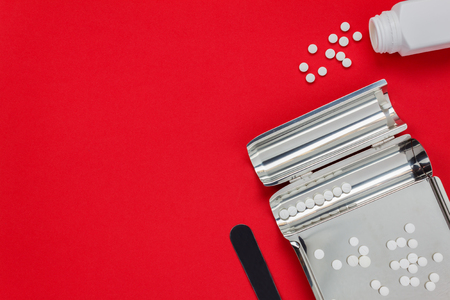 Top view medical concept the pills and tray pharmacy on red background with copy space.の写真素材