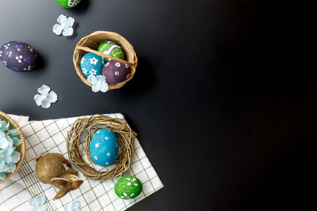 Top view accessories Happy Easter background.beautiful easter eggs painted on basket.Texture rustic wooden with decorations flowers  and doll rabbit with copy space.の写真素材