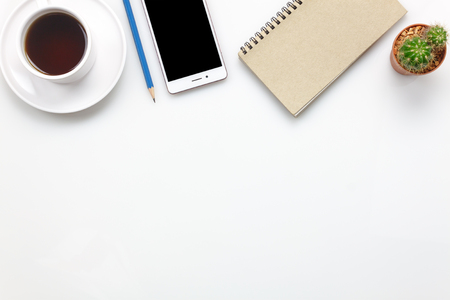 Top view accessories office desk concept.mobile phone,coffee,notepaper,pencil,cactus on office desk.の写真素材
