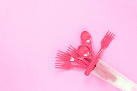 Top view colorful plastic spoon on pink table background with copy space.の写真素材