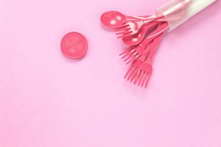 Top view colorful plastic spoon on pink table background with copy space.の写真素材