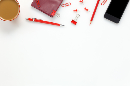 Top view accessories business office desk.mobile phone,coffee,notepaper,colorful pencil,clipboard,peg on white office desk with copy space.の写真素材