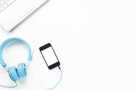 Top view  accessories office desk.smartphones headphones key board laptop on white background with copy space.の写真素材