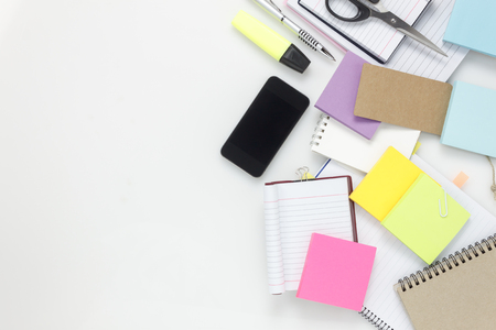 Top view  accessories business office desk.Smartphone notebook pen paper note on white background with copy space.の写真素材