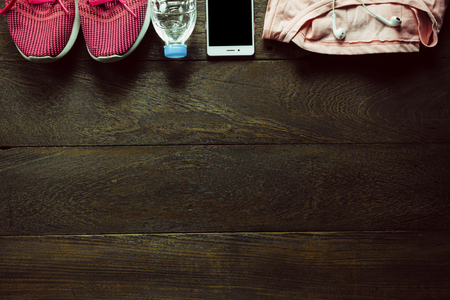 Top view accessories women sport on wooden with smart phone.の写真素材