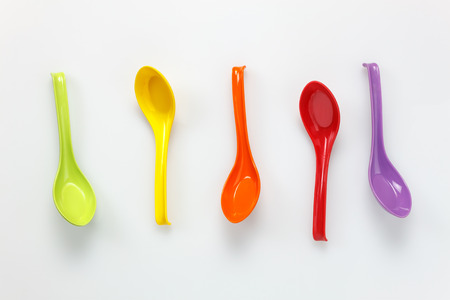 Top view colorful plastic spoon on white table background with copy space.の写真素材