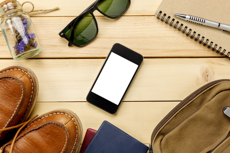 Top view accessories  travel with passport,flower,shoe,mobilephone,sunglasses,bag,watch,notepaper on table wooden with copy space.Travel concept.の写真素材