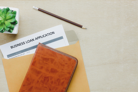 Top view business office desk background.The business loan appcation form pencil  letter and diary tree on wooden table background with copy space.の写真素材