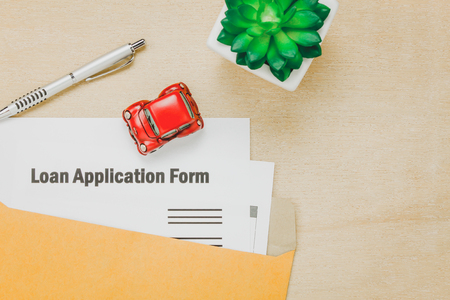 Top view business office desk background.The business loan appcation form pencil  letter and car tree on wooden table background with copy space.の写真素材