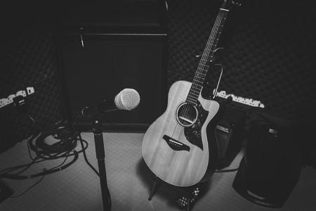 Black and White photo concept.the music band in the studio recording with Instrument is microphone classic guitar and speaker for live concert background.の写真素材