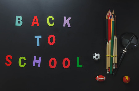 Top view colorful alphabet "BACK TO SCHOOL" with stationery office desk or items eduction on grunge backboard.sport equipment and magnify.flat lay copy space.の写真素材