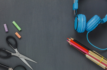 Top view stationery equipment on grunge blackboard background.Items or accessories to back to school or education concept.flat lay and copy space.の写真素材