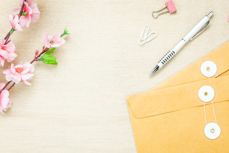 Top view business office desk background.The stationery desktop the ballpen letter flower clip on wooden table background with copy space.flat lay.above.の写真素材