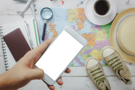 Top view / Flat lay hand using mobile phone on blur accessories to travel.の写真素材