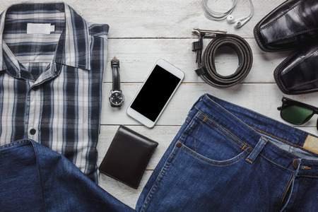 Top view / Flat lay accessoires to travel and technology with man / gentlemen clothing on white wooden tableの写真素材