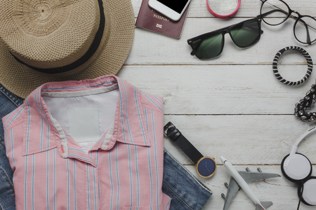 Flat lay of clothing women to travel concept background.Different verity of object on modern table office desk.Items garment for teenage or young and guy to trip.Free space for design text and word.の写真素材