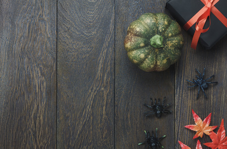 Table top of decoration sign Happy Halloween festival background. with beautiful pumpkin and maple leaf.Several object on modern rustic wooden desk.Copy space for text information.Dark tone design.の写真素材