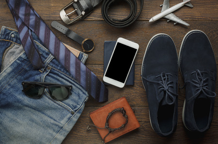 Table top view of accessories fashion men for travel with technology concept.Essential item for the teenage or adult gentlemen and travel for trip holidays.Mix of object on the modern rustic wooden.の写真素材