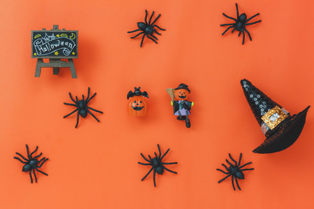 Flat lay of sign Happy Halloween festival background concept.Top of essential object on the modern rustic orange table wood with home decoration.Necessary items for ornament the season.の写真素材