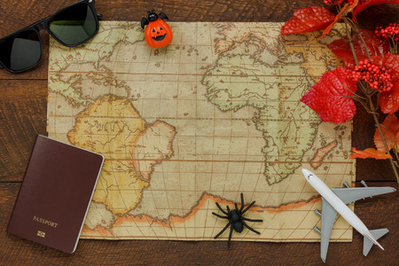 Above view of accessory Happy Halloween with items to travel background concept.Mix several object on the modern rustic brown wooden at home office desk.Equipment for traveler or teenage and adult.の写真素材