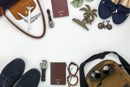 Top view of items for travel with fashion men & women background concept.Difference essential accessory on the white wood area.Copy space for creative font or text design.Objects for traveler on trip.の写真素材