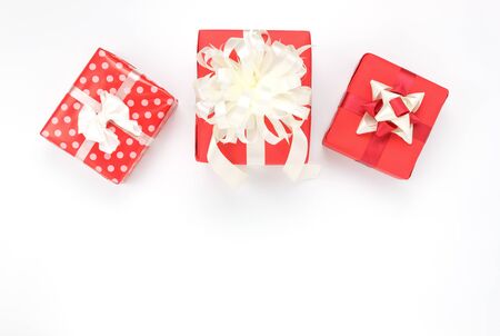 Overhead of accessories Happy new year or Happy Birthday or Merry Christmas concept.Mix side red gifts box on the modern white background at home table studio.Copy space creative design font or text.の写真素材
