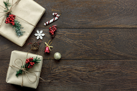 Top view of decoration & ornament Merry Christmas and Happy new year concept.Gift box set with sign season on the modern rustic dark brown wooden at home office desk.copy space for text and wording.の写真素材