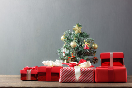 Many red gift box and Christmas fir tree on wooden background.Essential objects of sign Happy new year & Merry Christmas concept.Copy space for creative design text and font.winter season.の写真素材