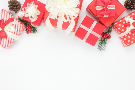 Above view of ornaments & decorations Happy new year & Merry Christmas concept.Essential accessories on modern white background.Variety red box and sign items for holiday arrangement on free space.の写真素材